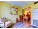 Sitting area flowing into a bedroom with a bed and a red dresser at 2460 Persian Dr # 26, Clearwater, FL 33763