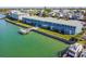 Aerial view showcasing waterfront building and boat at 250 126Th Ave # 206, Treasure Island, FL 33706