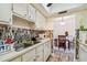 Kitchen with view into dining area, featuring white cabinets and dual sink at 250 126Th Ave # 206, Treasure Island, FL 33706