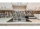 Clean kitchen sink and countertop with modern tile backsplash at 250 126Th Ave # 206, Treasure Island, FL 33706
