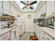 Bright kitchen features white cabinets, tile backsplash, and modern appliances at 250 126Th Ave # 206, Treasure Island, FL 33706
