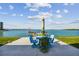 Relaxing patio furniture with umbrella overlooking the water at 250 126Th Ave # 206, Treasure Island, FL 33706