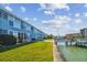Building with grassy area, dock, and boats in background at 250 126Th Ave # 206, Treasure Island, FL 33706