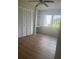 Bedroom with wood floors and window with a built-in desk at 2593 Countryside Blvd # 7213, Clearwater, FL 33761
