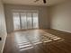 Bright bedroom with laminate flooring and sliding glass doors at 2593 Countryside Blvd # 7213, Clearwater, FL 33761