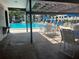 Community pool with tables and chairs and lounge chairs at 2593 Countryside Blvd # 7213, Clearwater, FL 33761