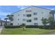 Well-maintained condo building featuring lush landscaping and a clean, bright facade at 2593 Countryside Blvd # 7213, Clearwater, FL 33761