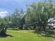 Landscaped common area with mature shade trees surrounding the community clubhouse at 2593 Countryside Blvd # 7213, Clearwater, FL 33761