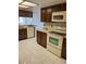 Well-equipped kitchen featuring wood cabinets and appliances at 2593 Countryside Blvd # 7213, Clearwater, FL 33761