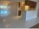 Well-lit kitchen flows into the living and dining areas, featuring white tile and appliances at 2593 Countryside Blvd # 7213, Clearwater, FL 33761
