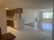 Bright and airy living room with tile, wood flooring, and seamless flow into the kitchen at 2593 Countryside Blvd # 7213, Clearwater, FL 33761