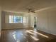 Living room with laminate floors, sliding doors, and balcony access at 2593 Countryside Blvd # 7213, Clearwater, FL 33761