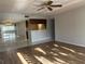 Spacious living room with wood-look floors and kitchen views at 2593 Countryside Blvd # 7213, Clearwater, FL 33761