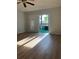 Spacious living room with laminate wood floors and sliding doors to balcony at 2593 Countryside Blvd # 7213, Clearwater, FL 33761