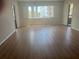 Inviting living room with wood flooring, plantation shutters, and access to outdoor space at 2593 Countryside Blvd # 7213, Clearwater, FL 33761