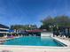 Residents enjoying a sunny day at the community pool with ample lounge chairs for relaxing at 2593 Countryside Blvd # 7213, Clearwater, FL 33761