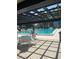 Community pool area with tables, chairs, and lounge seating for residents to relax and enjoy the water at 2593 Countryside Blvd # 7213, Clearwater, FL 33761