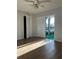 Bright bedroom with wood floors and access to a balcony at 2593 Countryside Blvd # 7213, Clearwater, FL 33761