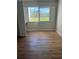 Bedroom with large window, wood-look floors and built-in desk at 2593 Countryside Blvd # 7213, Clearwater, FL 33761