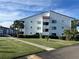 Two-story building with white exterior and palm trees at 2593 Countryside Blvd # 7213, Clearwater, FL 33761