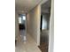 Bright hallway with tile flooring and access to bedrooms and bathrooms at 2593 Countryside Blvd # 7213, Clearwater, FL 33761