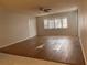 Bright living room with wood-look floors and ceiling fan at 2593 Countryside Blvd # 7213, Clearwater, FL 33761