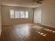 Spacious living room featuring wood-look floors and updated ceiling fan at 2593 Countryside Blvd # 7213, Clearwater, FL 33761
