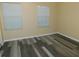 Bright bedroom featuring modern vinyl plank flooring and ample natural light streaming through the two large windows at 262 Countryside Key Blvd, Oldsmar, FL 34677