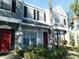Three-story townhouses with red doors and gray siding at 262 Countryside Key Blvd, Oldsmar, FL 34677