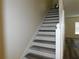 White staircase with wood-look vinyl treads at 262 Countryside Key Blvd, Oldsmar, FL 34677