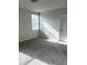 Bright bedroom with carpeted floor and large window at 3050 Forrest Plum Ct, Zephyrhills, FL 33540