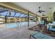 Inviting screened-in pool with poolside seating and views of the lake at 3360 Hickorywood Way, Tarpon Springs, FL 34688