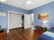 Light-filled bedroom with wood floors and a spacious closet at 3630 Shady Ln, Palm Harbor, FL 34683