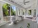 Cozy screened porch with rocking chairs and lush greenery at 3630 Shady Ln, Palm Harbor, FL 34683