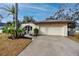 Single-story home with attached garage and manicured lawn at 391 Meravan Ct, Palm Harbor, FL 34683