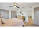 Bright bedroom with light pink bedding, dresser, and ceiling fan at 3911 King Dr, Brandon, FL 33511