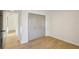 Simple bedroom with light wood floors and a double door closet at 3911 King Dr, Brandon, FL 33511