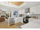 Modern kitchen with white cabinets, stainless steel appliances, and a unique wood ceiling at 3911 King Dr, Brandon, FL 33511