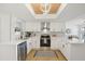 Modern kitchen with white cabinets, quartz countertops, and stainless steel appliances at 3911 King Dr, Brandon, FL 33511