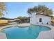 Freeform pool with concrete decking in backyard at 3911 King Dr, Brandon, FL 33511