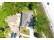 Aerial view of a well-maintained property featuring a gray roof, a driveway, and lush surroundings at 408 E Hanlon St, Tampa, FL 33604