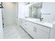 Spacious bathroom with dual sinks, white cabinets, and modern marble-look tile flooring at 408 E Hanlon St, Tampa, FL 33604
