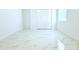 Bright bedroom featuring large closet, window and stylish marble-look tile flooring at 408 E Hanlon St, Tampa, FL 33604