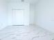 Bright bedroom featuring large closet, white walls and stylish marble-look tile flooring at 408 E Hanlon St, Tampa, FL 33604