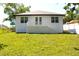 Charming home exterior featuring a clean white facade, a cozy balcony, and inviting curb appeal at 408 E Hanlon St, Tampa, FL 33604