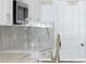 Modern kitchen features white cabinets, stainless steel appliances, and sleek countertops at 408 E Hanlon St, Tampa, FL 33604