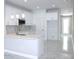 Modern kitchen with white cabinets, stainless steel microwave, and marble countertops at 408 E Hanlon St, Tampa, FL 33604