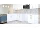 Contemporary kitchen showcasing white cabinets, stainless steel appliances, and sleek countertops at 408 E Hanlon St, Tampa, FL 33604