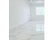 Bright living room features marble-look tile flooring and window allowing ample natural light at 408 E Hanlon St, Tampa, FL 33604