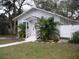 Front view of a white house with walkway and landscaping at 420 5Th N St, Safety Harbor, FL 34695